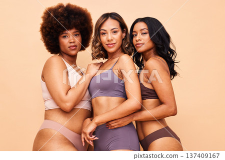 Diversity, body positivity and portrait of women in underwear with smile, self love and solidarity in studio. Happy face, people on beige background with cosmetics, skincare inclusion and equality. Diversity, body positivity and portrait of women in underwear with smile, self love and solidarity in studio. Happy face, people on beige background with cosmetics, skincare inclusion and equality. 137409167