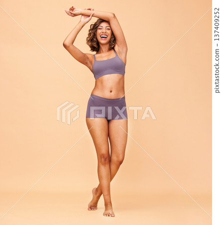 Self love, dance and body of woman in underwear in studio for care, positivity or happy portrait on wall background. Smile, freedom and female model dancing in celebration of acceptance or confidence 137409252