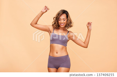 Self love, dance and happy woman in lingerie in studio with skincare, results and body positivity on wall background. Beauty, cosmetics and female model dancing for wellness, good mood or acceptance Self love, dance and happy woman in lingerie in studio with skincare, results and body positivity on wall background. Beauty, cosmetics and female model dancing for wellness, good mood or acceptance 137409255