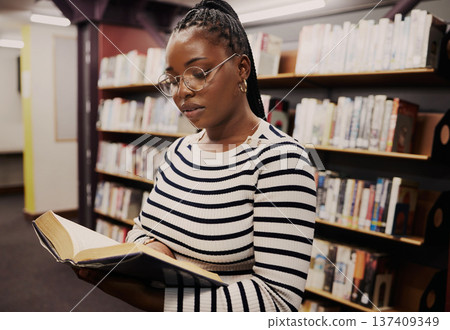 Black woman, library and books for school, student reading or education, English and language research. Young person focus by bookshelf for studying, literature catalog and free resources in glasses Black woman, library and books for school, student reading or education, English and language research. Young person focus by bookshelf for studying, literature catalog and free resources in glasses 137409349