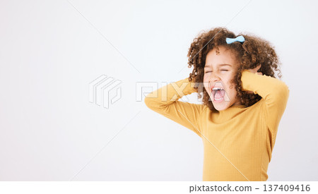 Screaming, loud and mockup with a girl child in studio on a white background covering her ears. Children, sound and audio with a young kid shouting or yelling on empty space for ADHD or autism 137409416