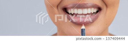 Makeup, beauty and lips of woman with pencil in studio for wellness, skincare product and cosmetics. Salon, banner and face zoom of person with lipstick or lip liner for glamour, makeover and glow 137409444