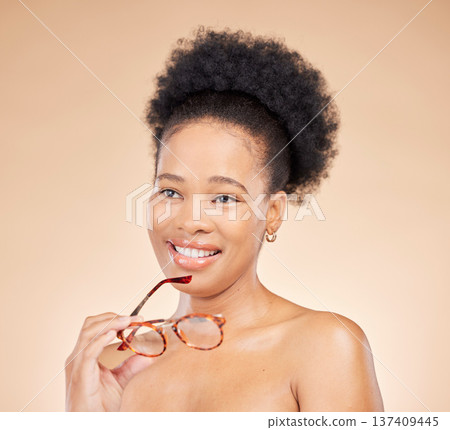 Beauty, thinking and black woman in studio with glasses, idea or smile for natural cosmetics on brown background. Happy, skincare and African lady model with idea for body care, wellness or treatment 137409445