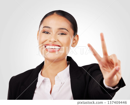 Happy business woman, portrait and peace sign in career ambition or positive mindset against a studio background. Face of female person or employee smile in happiness with emoji or hand gesture Happy business woman, portrait and peace sign in career ambition or positive mindset against a studio background. Face of female person or employee smile in happiness with emoji or hand gesture 137409446