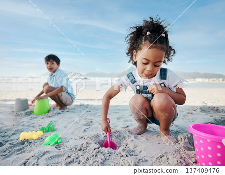 Boy, girl and shovel with bucket, beach and digging sand with playing, outdoor and vacation in summer. Kids, siblings and plastic toys for sandcastle, construction game and happy for holiday by ocean Boy, girl and shovel with bucket, beach and digging sand with playing, outdoor and vacation in summer. Kids, siblings and plastic toys for sandcastle, construction game and happy for holiday by ocean 137409476