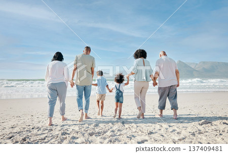 Family, holding hands and relax outdoor on a beach with love, care and happiness for summer vacation. Behind, space in sky or travel with men, women and children together at sea for holiday adventure Family, holding hands and relax outdoor on a beach with love, care and happiness for summer vacation. Behind, space in sky or travel with men, women and children together at sea for holiday adventure 137409481