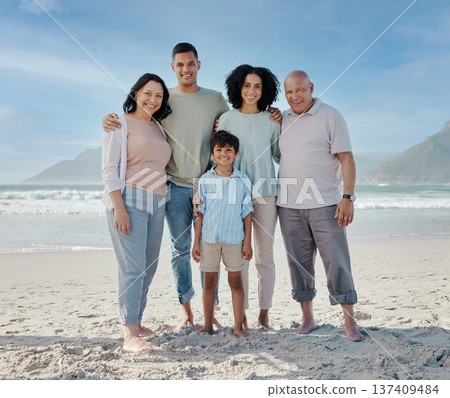 Portrait, grandparents and a family on the beach in nature together for holiday or vacation by the ocean. Love, summer or freedom with parents and children at the sea for bonding or weekend travel 137409484