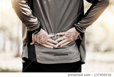 Runner, hands and back pain in park, injury or outdoor for fitness, training or muscle emergency. Person, spine accident and exercise for osteoporosis, fibromyalgia or arthritis in nature for workout Runner, hands and back pain in park, injury or outdoor for fitness, training or muscle emergency. Person, spine accident and exercise for osteoporosis, fibromyalgia or arthritis in nature for workout 137409530