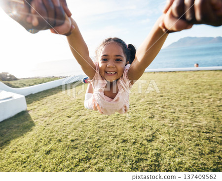 Girl, spin and outdoor portrait in pov, holding hands or happy for game with parent, holiday or backyard. Female child, smile and swing in air, fast or excited for play on vacation in summer sunshine 137409562