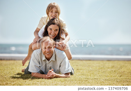 Portrait, mockup and family in a pile on grass by the ocean together for travel, vacation or holiday in a summer. Love, smile or happy with a dad, mom and son on the ground in a stack at the sea Portrait, mockup and family in a pile on grass by the ocean together for travel, vacation or holiday in a summer. Love, smile or happy with a dad, mom and son on the ground in a stack at the sea 137409706