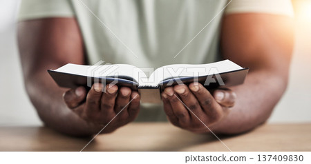 Bible, book reading and hands with closeup of religion study at home for worship and spiritual support. Faith, christian knowledge and person with gratitude, scripture education and god guidance Bible, book reading and hands with closeup of religion study at home for worship and spiritual support. Faith, christian knowledge and person with gratitude, scripture education and god guidance 137409830