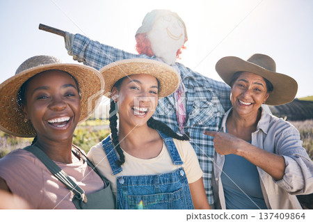 Farmer, women and selfie in countryside with comedy and scarecrow outdoor with a smile. Diversity, worker group and portrait with social media and profile picture on a agro farm with sustainability Farmer, women and selfie in countryside with comedy and scarecrow outdoor with a smile. Diversity, worker group and portrait with social media and profile picture on a agro farm with sustainability 137409864