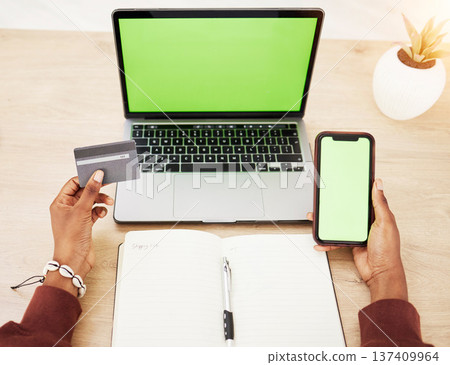 Woman, hands and laptop with phone green screen mockup and credit card in online shopping or banking at office. Female person with debit on computer or smartphone app display in ecommerce or fintech 137409964
