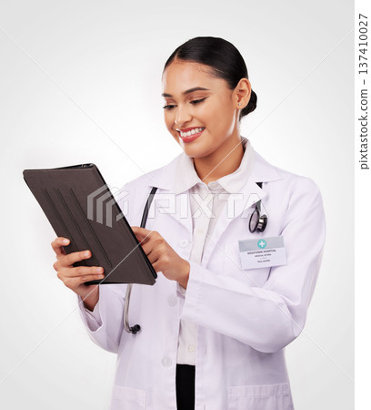 Happy woman, doctor and tablet in medical research, communication or Telehealth against a studio background. Female person, nurse or healthcare professional smile on technology for online networking Happy woman, doctor and tablet in medical research, communication or Telehealth against a studio background. Female person, nurse or healthcare professional smile on technology for online networking 137410027