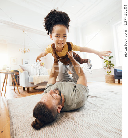 Father, child and airplane game on floor, playing and excited with care, love and lift in air, living room or house. Dad, kid and playful with plane, flying and bonding in interracial family home Father, child and airplane game on floor, playing and excited with care, love and lift in air, living room or house. Dad, kid and playful with plane, flying and bonding in interracial family home 137410104