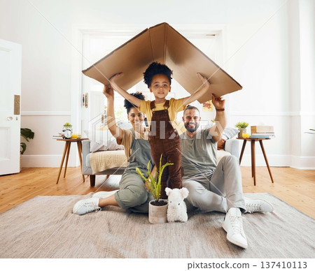 Portrait, family and a boy with cardboard for insurance in the living room of their home together. Mother, father and daughter in a house for security or safety in real estate and property finance Portrait, family and a boy with cardboard for insurance in the living room of their home together. Mother, father and daughter in a house for security or safety in real estate and property finance 137410113