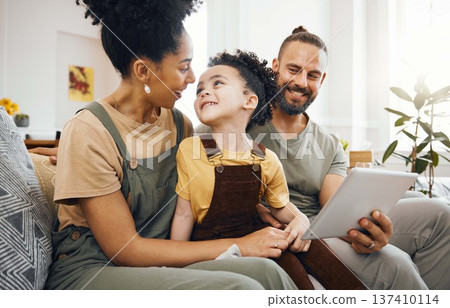 Home, family and parents with a tablet, boy and connection with games, cartoon and relax. People, mother or father with their son, child or kid on a sofa, technology or social media with conversation 137410114