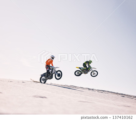 Sports, jump and people on motorcycle driving on sand, beach or training for a challenge, competition or desert rally mockup. Dirt, motorbike and fearless extreme stunt or jumping in space or air Sports, jump and people on motorcycle driving on sand, beach or training for a challenge, competition or desert rally mockup. Dirt, motorbike and fearless extreme stunt or jumping in space or air 137410162