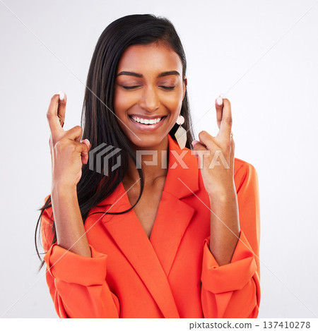 Face, smile and woman with fingers crossed in studio for good luck, hope or wish on white background. Happy, excited and female model with optimistic hand emoji review ,feedback or waiting for news 137410278