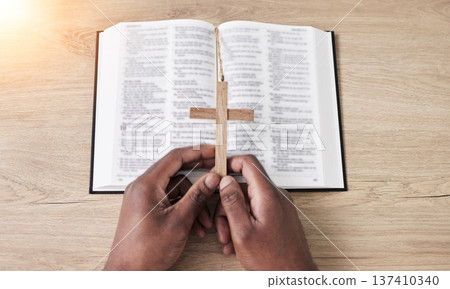 Bible, reading and cross with hands with book and religion study at home for worship and spiritual support. Faith, christian knowledge and person with gratitude, scripture education or above guidance Bible, reading and cross with hands with book and religion study at home for worship and spiritual support. Faith, christian knowledge and person with gratitude, scripture education or above guidance 137410340