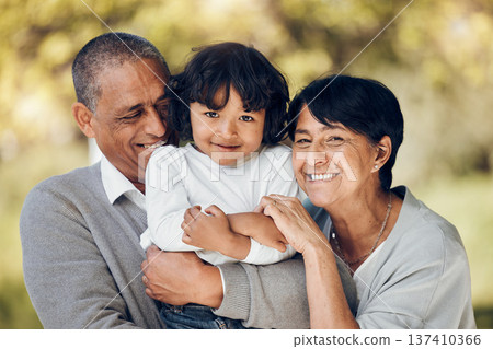 Family, portrait and hug by child and grandparents in a park with care, bond and fun on blurred background. Love, smile and face of senior people embrace retirement freedom with kid in a forest Family, portrait and hug by child and grandparents in a park with care, bond and fun on blurred background. Love, smile and face of senior people embrace retirement freedom with kid in a forest 137410366
