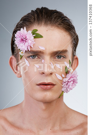 Head, cosmetics and flowers with portrait of man in studio for beauty, natural skincare and creative. Glow, serious and floral with face of model on white background for makeup, spa and wellness Head, cosmetics and flowers with portrait of man in studio for beauty, natural skincare and creative. Glow, serious and floral with face of model on white background for makeup, spa and wellness 137410368