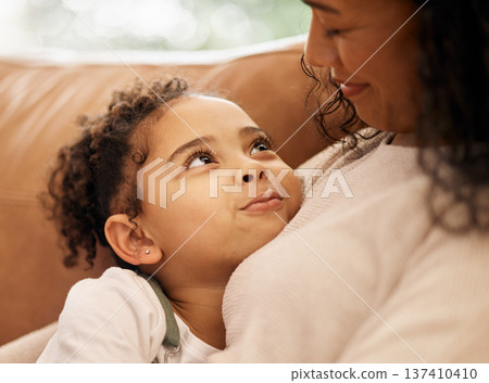 Love, hug and mother with girl child on a sofa with trust, support and bond at home together. Family, relax and face of kid embrace mom in a living room with conversation, safety or security in house 137410410