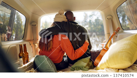 Hug, winter and a couple in a car for a road trip, date or watching the view together. Happy, travel and back of a man and woman with an affection in transport during a holiday or camping in nature Hug, winter and a couple in a car for a road trip, date or watching the view together. Happy, travel and back of a man and woman with an affection in transport during a holiday or camping in nature 137410574