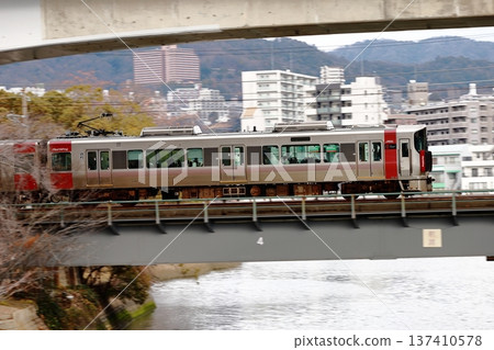 JR Red Wing train running through Hiroshima city and cityscape JR Red Wing train running through Hiroshima city and cityscape 137410578