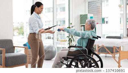 Woman with disability, physiotherapy and dumbbell exercise for healthcare assessment, test or digital checklist of medical progress. Physiotherapist, tablet or consulting senior patient in wheelchair Woman with disability, physiotherapy and dumbbell exercise for healthcare assessment, test or digital checklist of medical progress. Physiotherapist, tablet or consulting senior patient in wheelchair 137410691