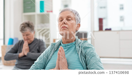 Senior people, yoga class and coach meditation, prayer and peace hands for exercise, holistic wellness and mindfulness. Spiritual workout, group and calm elderly women, clients and personal trainer 137410698