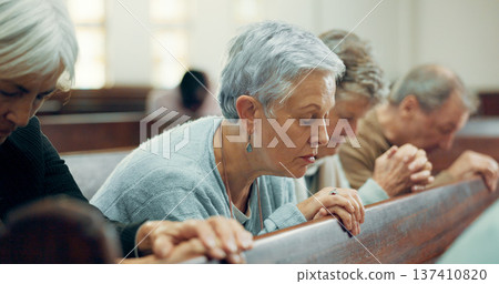 Elderly, prayer or old woman in church for God, holy spirit or religion in cathedral or Christian community. Faith, spiritual lady or senior person in chapel or sanctuary to praise Jesus Christ 137410820
