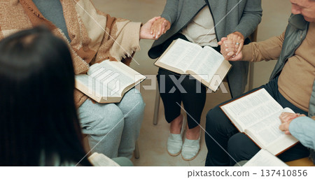 Praying, closeup and holding hands with people in bible study for support, Christian and spiritual. Community, faith and religion with prayer group in church for connection, worship and meeting 137410856