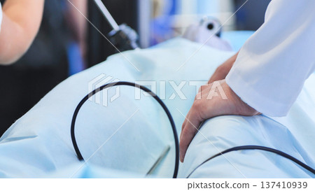 Surgeon performing modern endoscopic surgery with medical instruments and tools Surgeon performing modern endoscopic surgery with medical instruments and tools 137410939