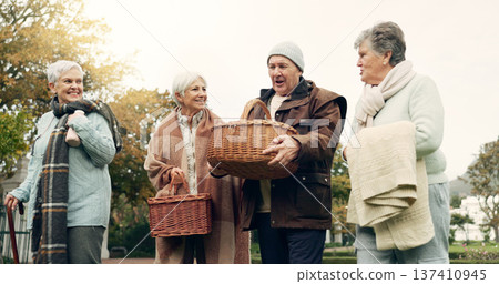 Walking, picnic and senior friends in the park together for bonding or conversation during retirement. Smile, basket and a group of happy elderly people in a garden for freedom, fresh air to relax 137410945