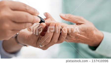 Hands, diabetes test and a doctor with a patient for a healthcare check with a finger prick. Closeup, service and a nurse with a person and machine for sugar or glucose exam from a blood sample Hands, diabetes test and a doctor with a patient for a healthcare check with a finger prick. Closeup, service and a nurse with a person and machine for sugar or glucose exam from a blood sample 137410996