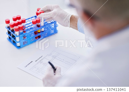 Science, blood sample and hands with test tube and notes for research, medical study and DNA in lab. Healthcare, pharmaceutical and scientist with vial writing for data analysis, report or checklist 137411041