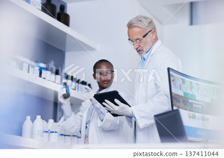 Science, black woman and man with tablet in laboratory for inventory list of chemicals for biotech research. Scientist team in lab with digital checklist for stock of pharmaceutical product in study. Science, black woman and man with tablet in laboratory for inventory list of chemicals for biotech research. Scientist team in lab with digital checklist for stock of pharmaceutical product in study. 137411044