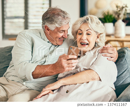 Relax, phone and funny with old couple on sofa for streaming, social media and communication. Excited, internet and website with senior man and woman laughing in living room at home for news and app Relax, phone and funny with old couple on sofa for streaming, social media and communication. Excited, internet and website with senior man and woman laughing in living room at home for news and app 137411167