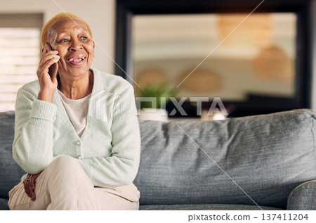 Phone call, senior woman and living room with conversation and communication in a home. Retirement, African elderly female person and mobile discussion on a lounge sofa with contact and talking Phone call, senior woman and living room with conversation and communication in a home. Retirement, African elderly female person and mobile discussion on a lounge sofa with contact and talking 137411204
