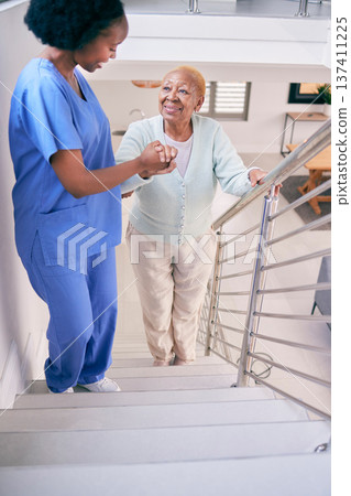 Caregiver, stairs and elderly woman holding hands, help and assistance in home. Nurse, steps and senior African patient walking up, support of person with a disability and happiness in healthcare Caregiver, stairs and elderly woman holding hands, help and assistance in home. Nurse, steps and senior African patient walking up, support of person with a disability and happiness in healthcare 137411225
