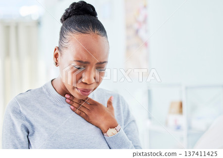 Sick, chest and black woman with sore throat at home for influenza, cold or allergies on wall background. Cough, tuberculosis and African lady choking, infection or breathing, lung or problem Sick, chest and black woman with sore throat at home for influenza, cold or allergies on wall background. Cough, tuberculosis and African lady choking, infection or breathing, lung or problem 137411425