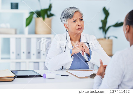 Doctor, serious woman and office in consultation, support and services, helping or medical advice. Nurse or senior expert listening to patient history or healthcare, consulting and clinic information 137411432