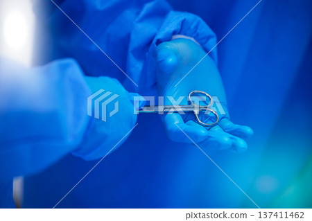Closeup, surgery and hands with a scissor for healthcare, hospital work and help. Support, team and doctors, surgeons or medical employees with gloves for cardiology or professional cooperation 137411462