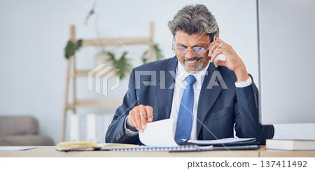 Business man, reading documents and phone call for contract negotiation, legal advice and compliance at desk. Corporate lawyer, smartphone and data analysis with paperwork, notes and smile in office Business man, reading documents and phone call for contract negotiation, legal advice and compliance at desk. Corporate lawyer, smartphone and data analysis with paperwork, notes and smile in office 137411492