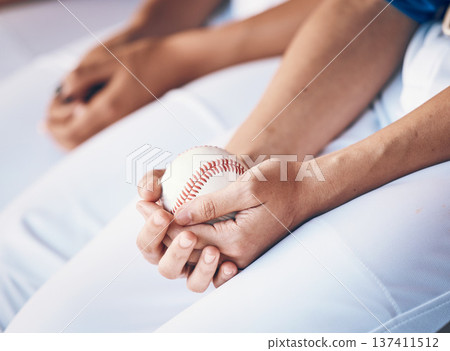 Hands, sports and baseball with a player in a dugout, waiting during a game of competition closeup. Ball, ready and uniform with an athlete holding equipment for a match in a stadium or venue 137411512
