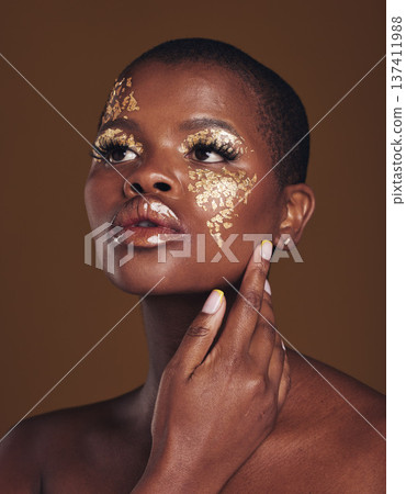 Art, aesthetic and black woman with gold makeup and brown background with glitter, paint and cosmetics. Shine, glow and African model in studio for beauty, fashion and freedom in luxury skincare. 137411988