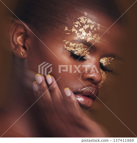 Gold beauty, blur and black woman with hand on face closeup with makeup and cosmetics in studio. Brown background, African female model and manicure with golden shine and glow from paint sparkle Gold beauty, blur and black woman with hand on face closeup with makeup and cosmetics in studio. Brown background, African female model and manicure with golden shine and glow from paint sparkle 137411989