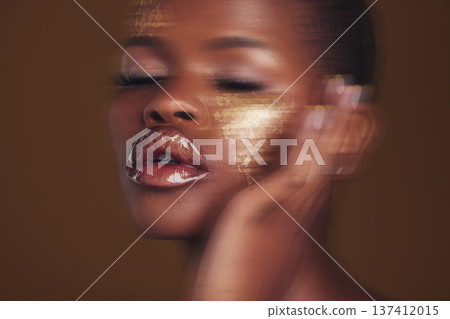 Gold beauty, makeup and woman skincare with blur in studio with glitter cosmetics and sparkle art. Brown background, African female model and shine from paint and glow with golden luxury treatment Gold beauty, makeup and woman skincare with blur in studio with glitter cosmetics and sparkle art. Brown background, African female model and shine from paint and glow with golden luxury treatment 137412015