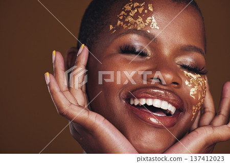 Gold, laughing and woman face closeup with makeup and luxury treatment with rich spa mask. Glitter, golden dermatology and African person happy from creative skincare and art cosmetics in studio 137412023